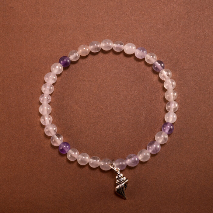 A 4mm Amethyst beaded bracelet with S925 charm arranged neatly on a minimal light background