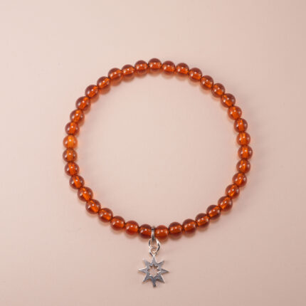 Garnet bracelet with silver star charm on a clean white background