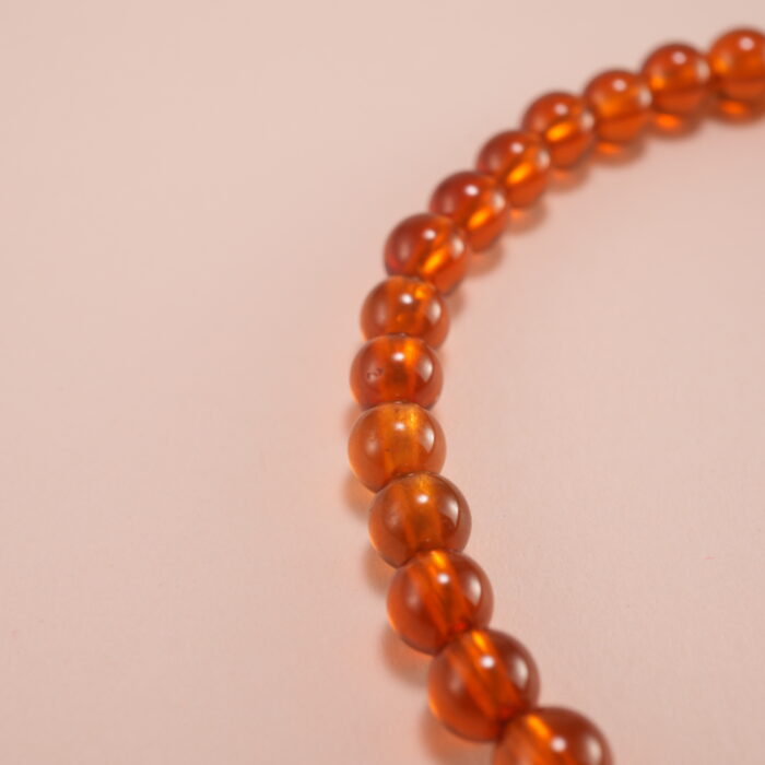 Close-up view of garnet beads and sterling silver star charm