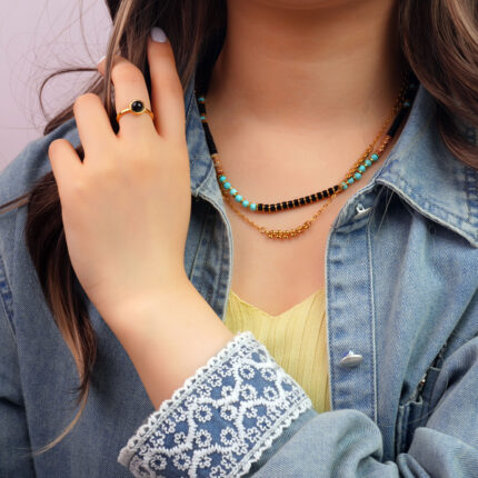 Model wearing the necklace, showing elegant contrast and grounding presence
