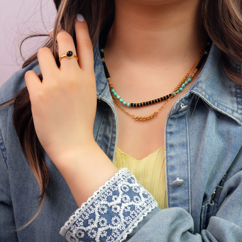 Model wearing the necklace, showing elegant contrast and grounding presence