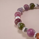 Close-up of Multicolor Tourmaline Beads and Silver Cross Charm