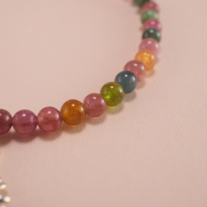 Close-up of Tourmaline Beads and Silver Charms – Vibrant Charm Bracelet