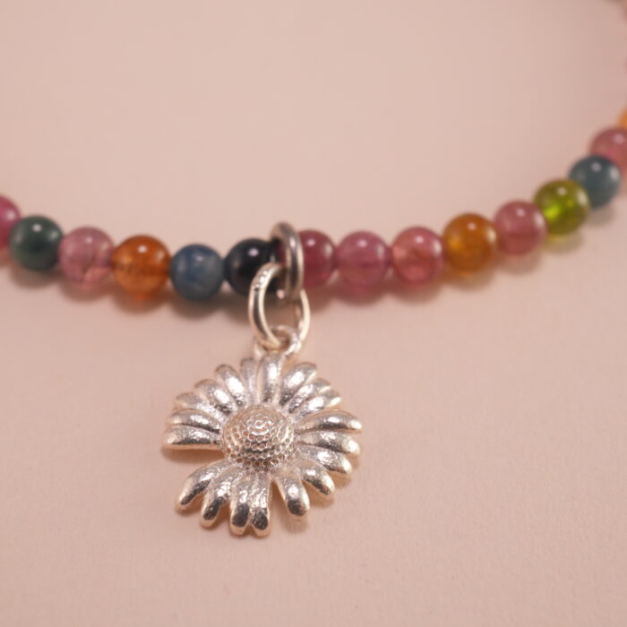 Close-up of Tourmaline Beads and Silver Charms – Vibrant Charm Bracelet