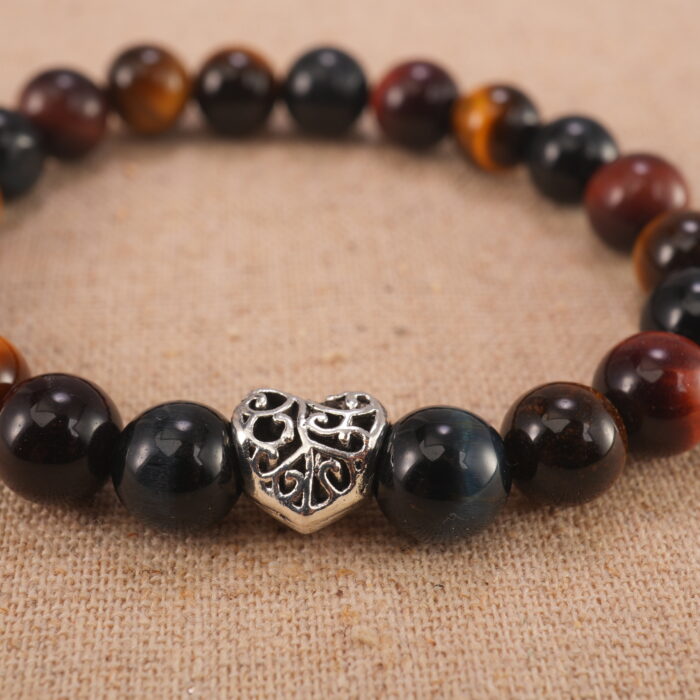 Close-up of heart charm and polished Tiger Eye beads