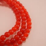 Close-up of red agate beads and silver charm details