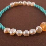 Close-up of turquoise and pearl beads on bracelet