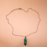 Handmade turquoise point pendant on a clean, white or soft neutral background