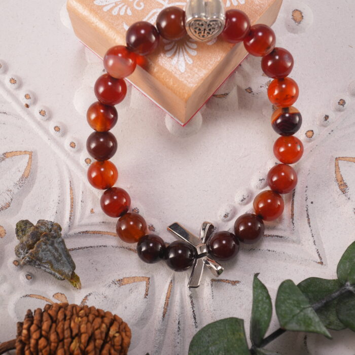 Heart bracelet styled with soft floral props for a romantic, energizing look