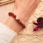 8mm red agate bracelet worn on wrist, showcasing rich color and minimalist style