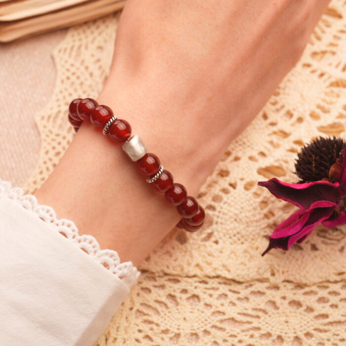 8mm red agate bracelet worn on wrist, showcasing rich color and minimalist style