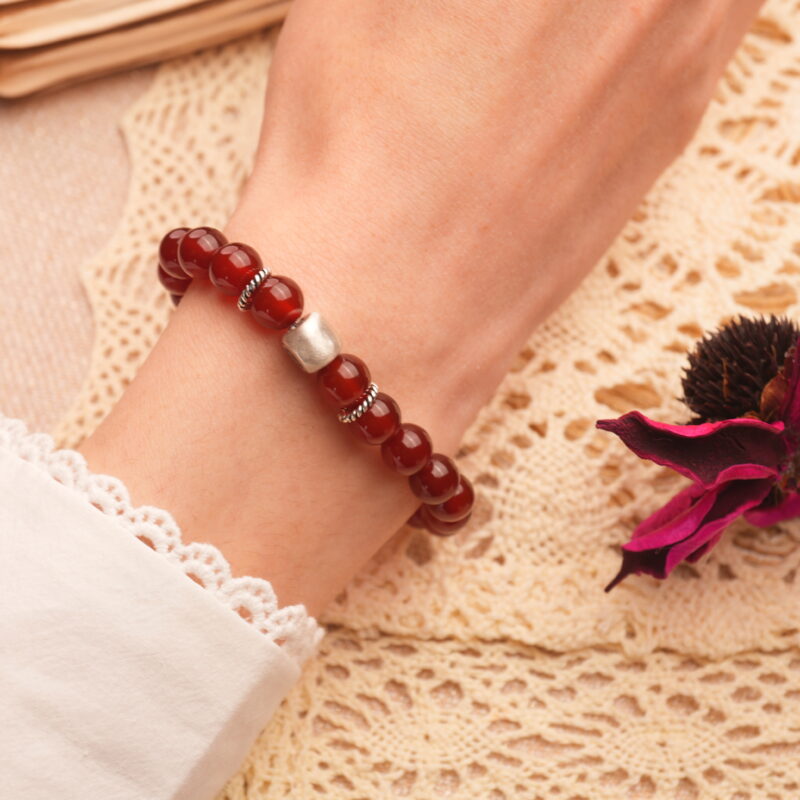 8mm red agate bracelet worn on wrist, showcasing rich color and minimalist style