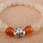 Close-up of the heart-shaped agate bead and surrounding polished stones