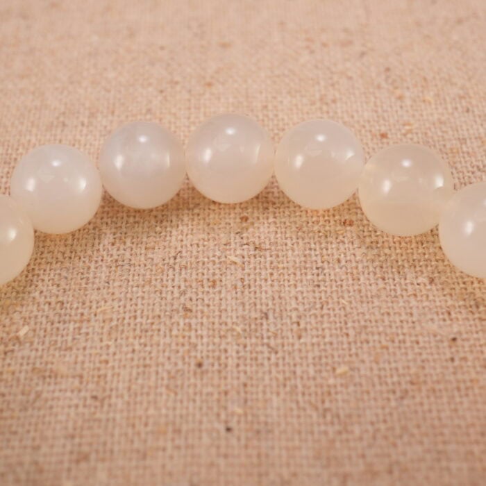 Close-up of the heart-shaped agate bead and surrounding polished stones