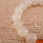 Close-up of the heart-shaped agate bead and surrounding polished stones