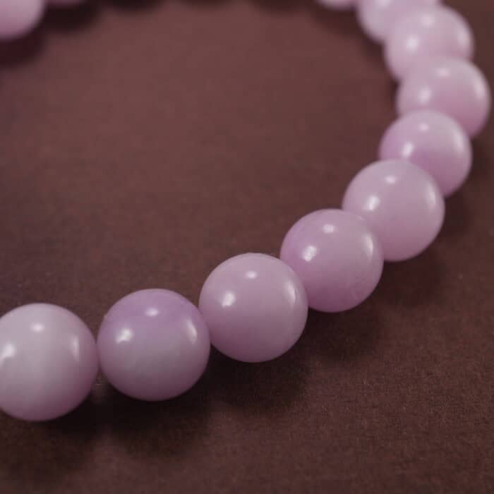 Close-up of kunzite beads showing natural texture and soft color variations