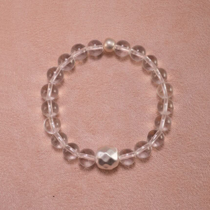 Clear quartz 8mm bracelet with silver accents on white background