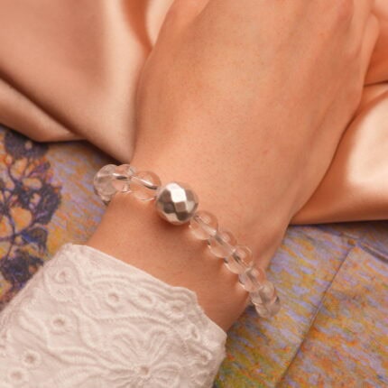 Worn on wrist, showcasing its bright, clean appearance and elegant shimmer