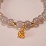 Close-up of polished agate beads and silver charm
