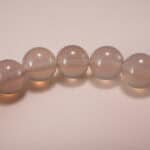 Close-up of polished agate beads and silver charm
