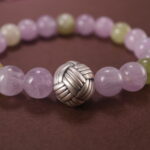 Close-up showing light pink Kunzite and soft green Prehnite beads