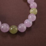 Close-up showing light pink Kunzite and soft green Prehnite beads