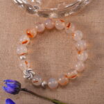 Crystal bracelet resting in a calm natural setting
