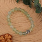 Prehnite bracelet placed next to calming natural elements