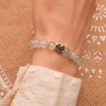 Model wearing 8mm Prehnite bracelet with heart accents