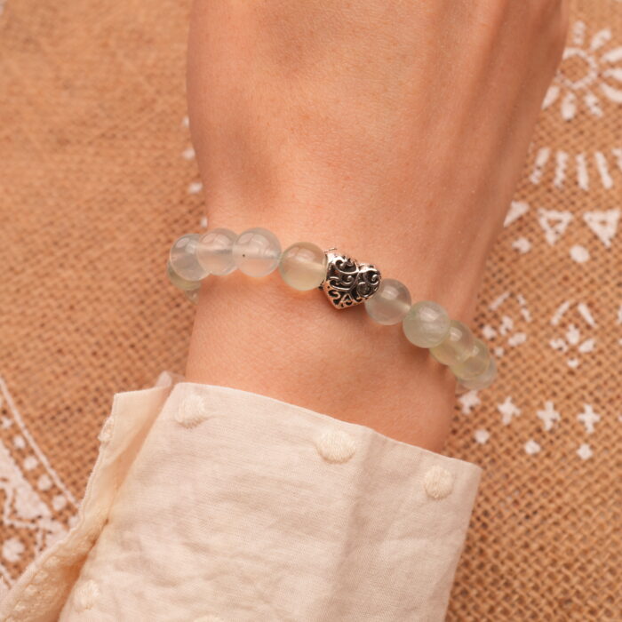 Model wearing 8mm Prehnite bracelet with heart accents
