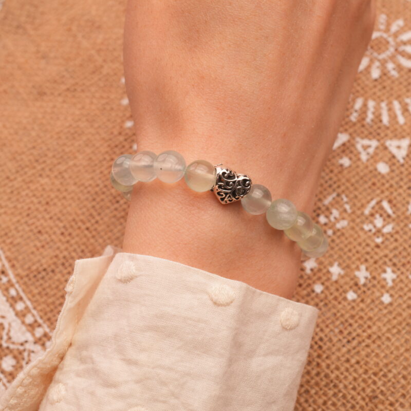 Model wearing 8mm Prehnite bracelet with heart accents