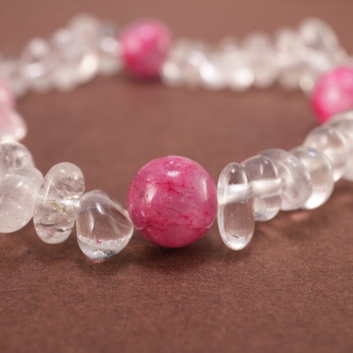Close-up of rough-cut Clear Quartz with polished Gray Agate beads