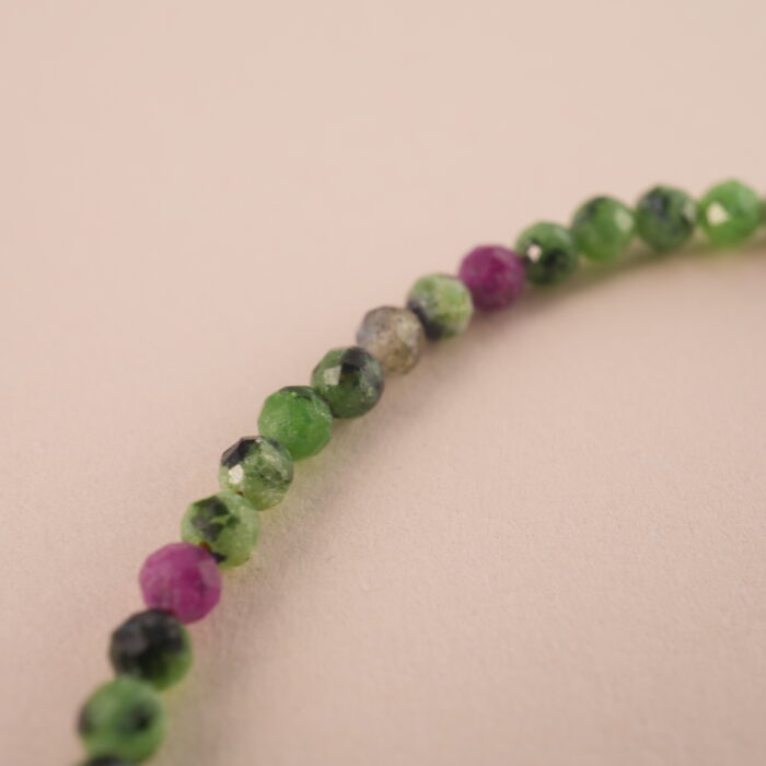 Close-up of Ruby Zoisite stones in round polished beads
