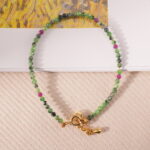 Ruby Zoisite bracelet placed on a linen fabric background