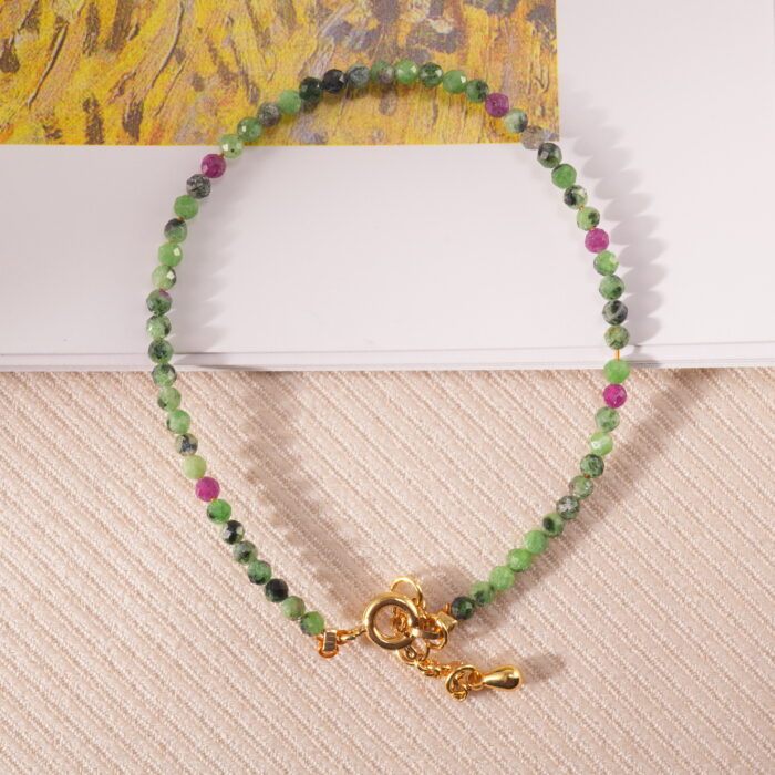 Ruby Zoisite bracelet placed on a linen fabric background