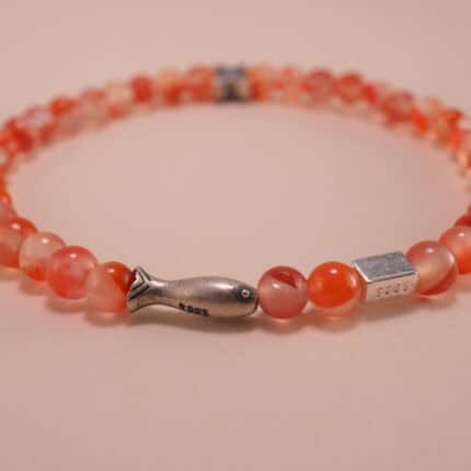Close-up of carnelian beads and silver detailing on 4mm bracelet