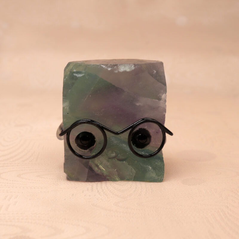 Natural Fluorite hedgehog figurine with multicolor tones on white background