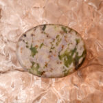 Green Cherry Blossom Agate worry stone with soft pink and green hues