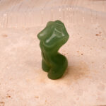 Polished Natural Green Onyx Model Figurine with rich green hues and smooth finish, displayed on a light surface