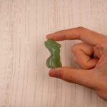 Hand holding Natural Green Onyx Model Figurine, showing its elegant shape and natural green color patterns