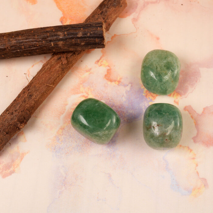 Green Strawberry Quartz Tumbled Stone placed in a calming meditation setting
