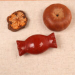 Red Jade Candy Figurine displayed with candles and crystals in a peaceful meditation setting