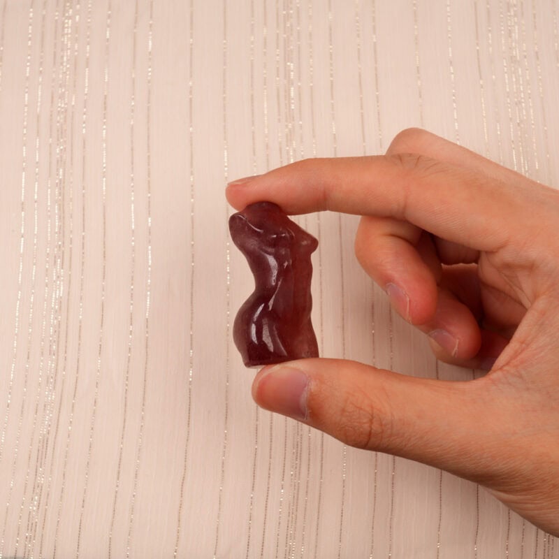 Hand holding a Natural Strawberry Quartz Model Figurine, showcasing its smooth texture and soft pink color