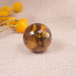 Tiger Skin quartz sphere placed on a desk or shelf as decorative crystal