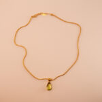 Peridot teardrop pendant necklace on a white or soft background