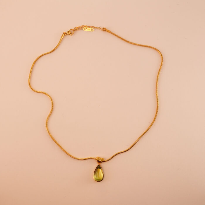 Peridot teardrop pendant necklace on a white or soft background