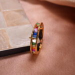 Rainbow Ring featuring vibrant zircon gemstones in multiple colors, displayed on a white background highlighting its brilliance