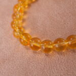 Close-up of polished Tiger Eye and Azeztulite beads showing golden chatoyancy