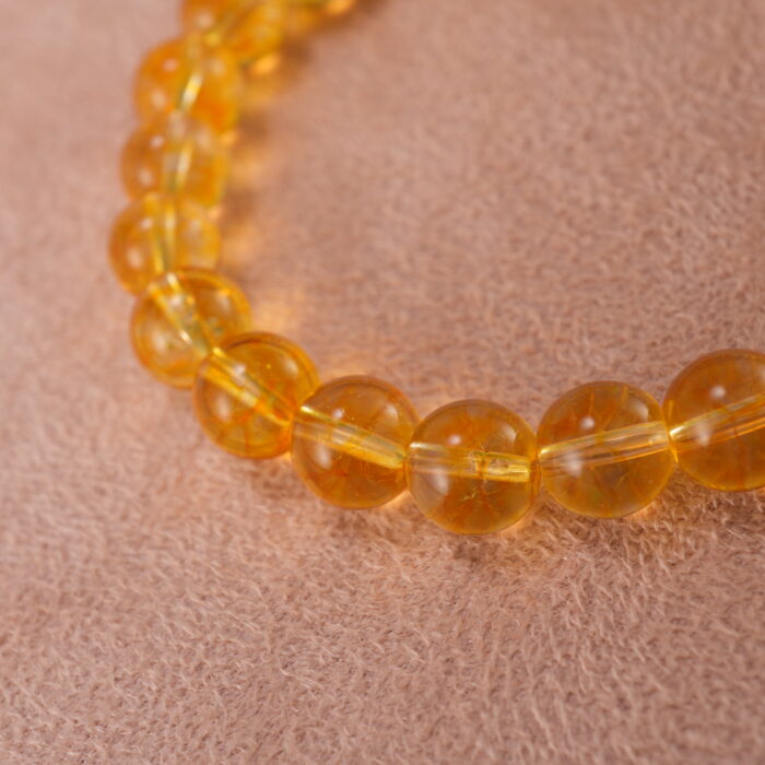 Close-up of polished Tiger Eye and Azeztulite beads showing golden chatoyancy