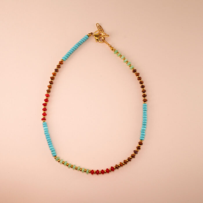 Handmade Tibetan turquoise, tiger eye and chalcedony necklace on white background